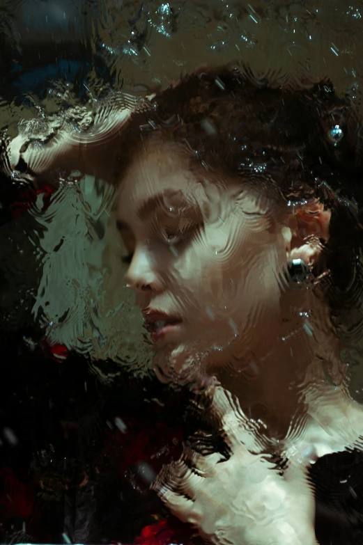 a reflection of a woman's face is shown in a water - filled po