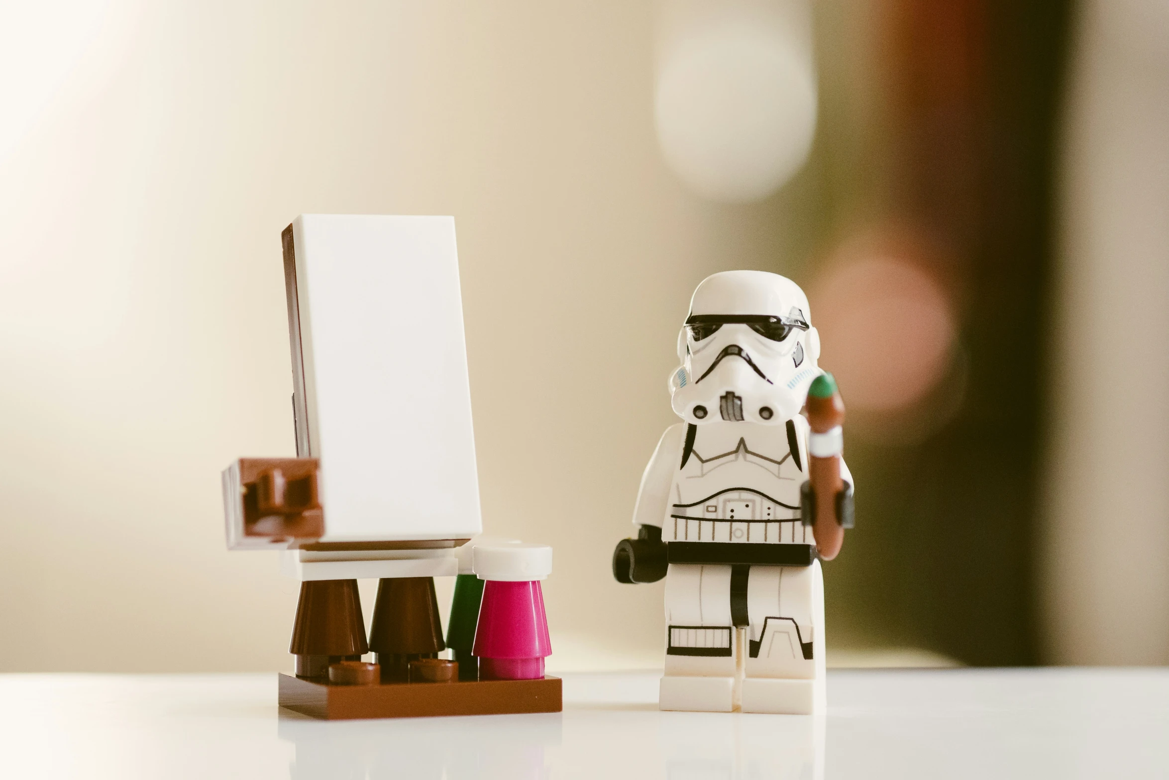 a lego storm trooper standing next to an easel and a toy