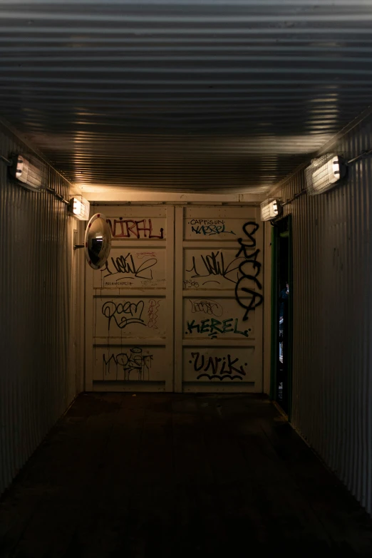 two graffiti covered wall walls with signs and lights on them