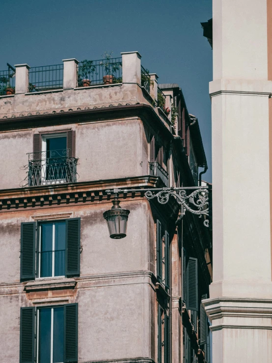 a clock is hanging off a pole in front of an old building