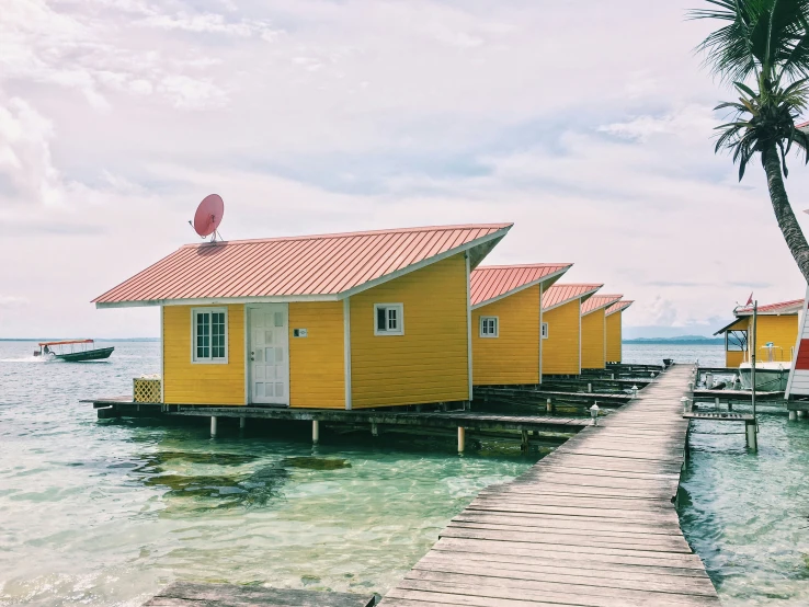 some tiny yellow houses floating in the ocean