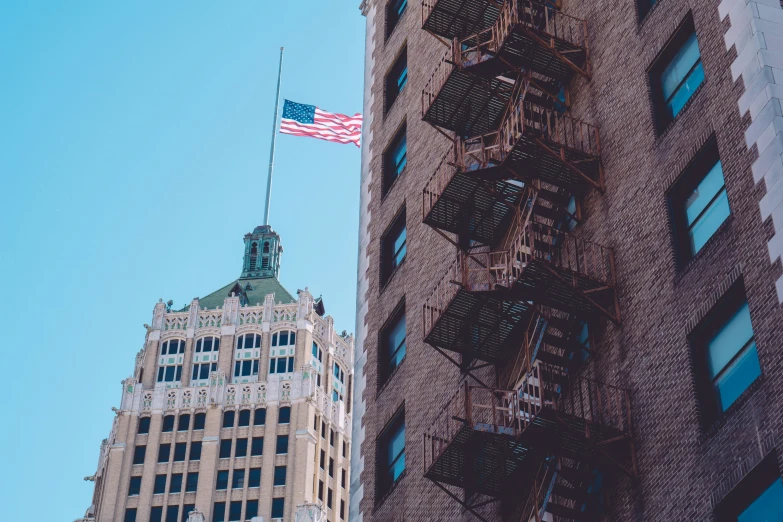 a tall building with several ladders and chairs attached to it