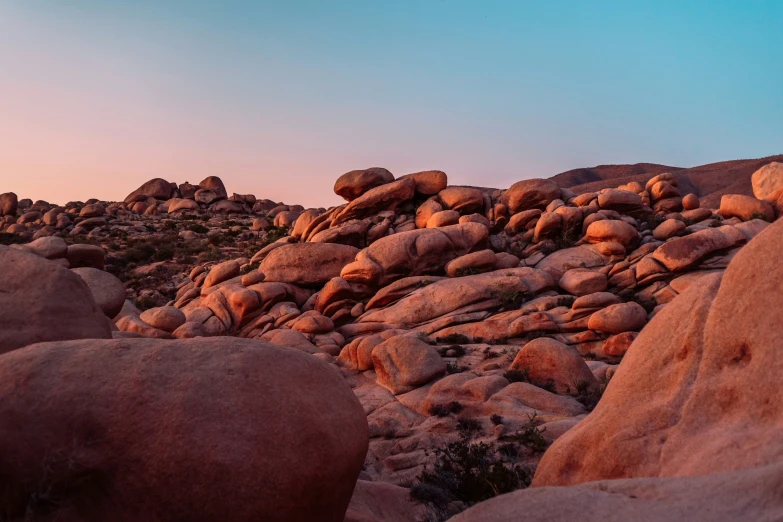 rocks of various sizes and shapes stand against the blue sky