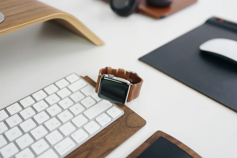 an apple watch is sitting on a table by some other things