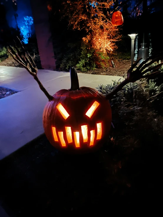 a lighted jack o lanterns pumpkin with it's eyes glowing