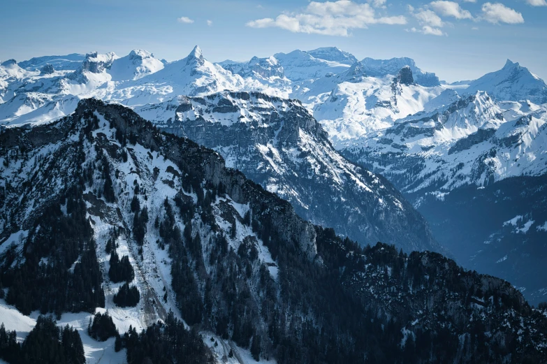 the mountains and a ski area are covered in snow