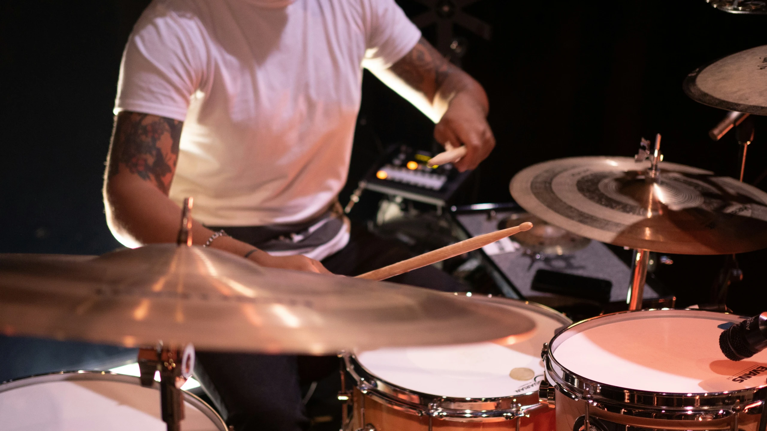 a man is playing on some drums and his drum set up