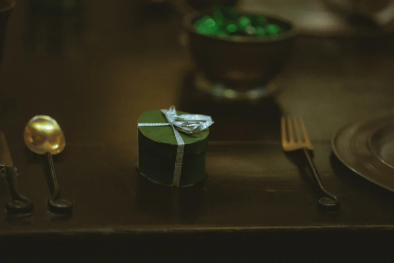 a green box is wrapped in foil on the plate