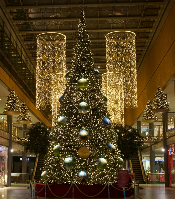 a very big christmas tree in a big building