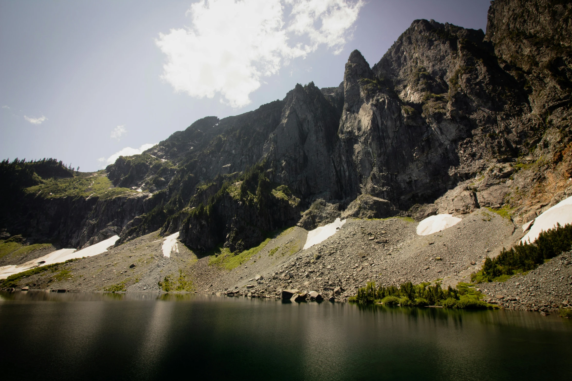 the mountain side is made up of large rocky walls and small cliffs