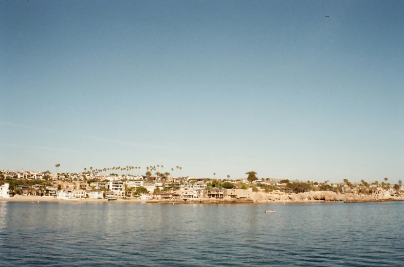 a view from the side of a boat shows the houses that rise above the water