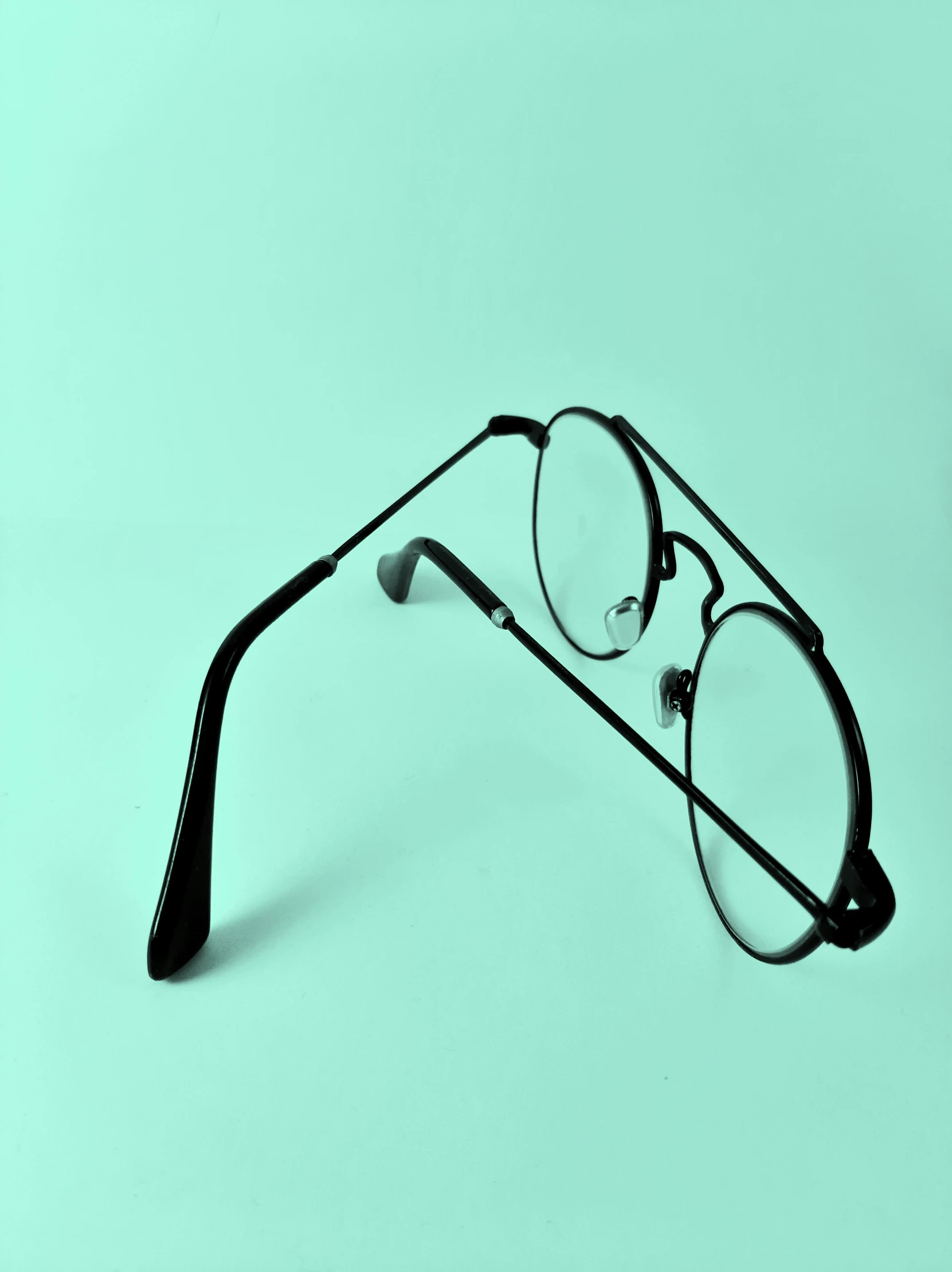 a pair of glasses lying on top of each other