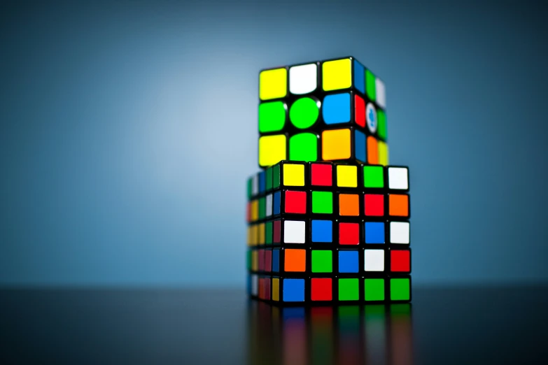 two blocks of different colored cubes sitting on a table