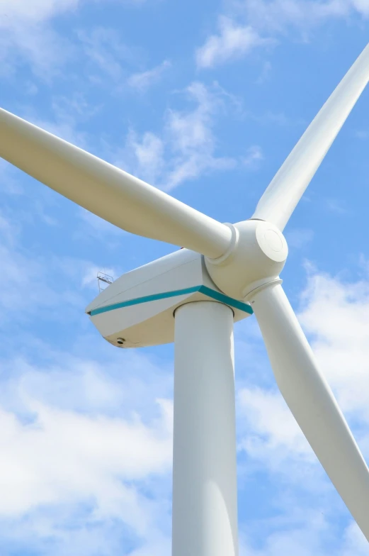 an image of wind turbine that looks as if it is about to make contact with another wind turbine