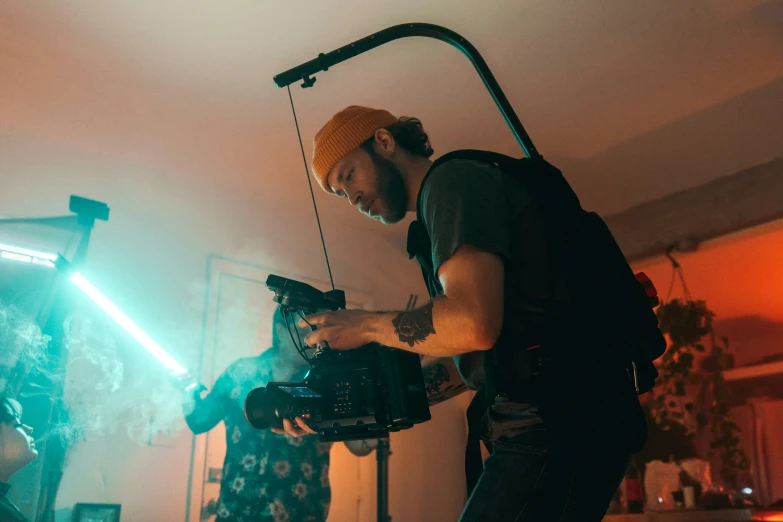 a man holding up his camera and standing near another man