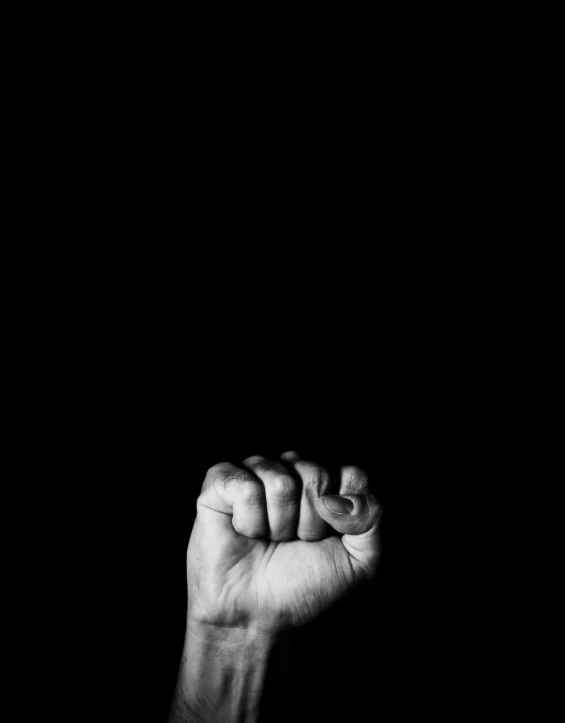 a man holding his fist up in the air