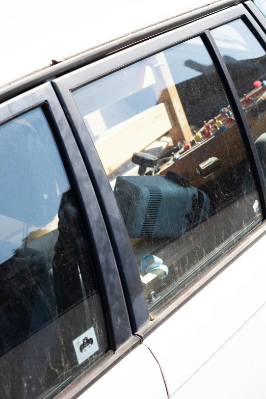 the reflection of suitcases in the windows of a car