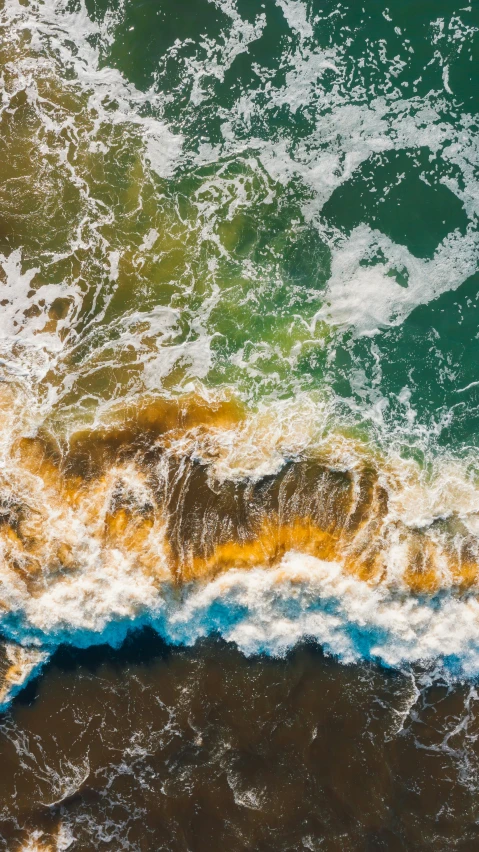 the top view of waves coming from the ocean