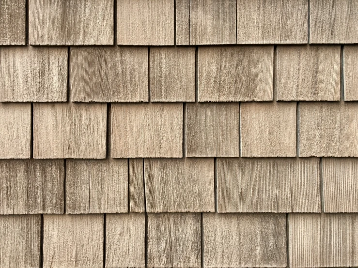 the top of a shingled house with wood grains