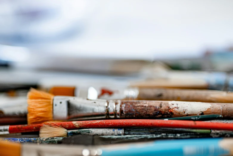 some old and rusty paintbrushes laying together