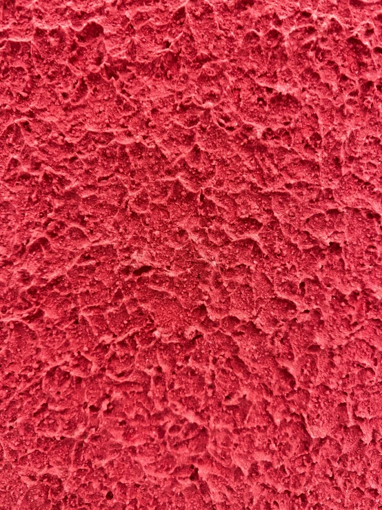 the textured surface of a red stucco