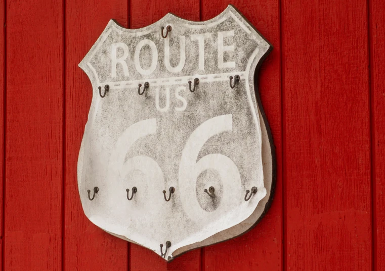 a route 66 sign on the side of a red barn