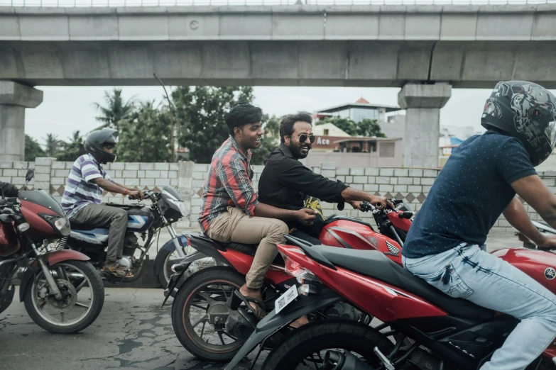 people are riding on motorcycles down a street