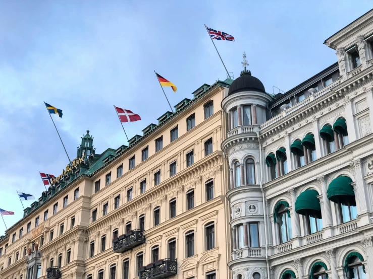 multiple flags in the middle of an old style building