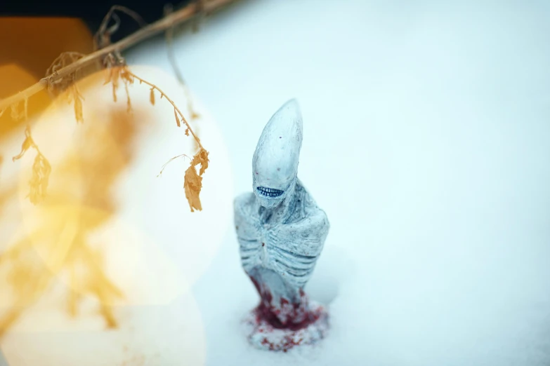 someone's hand holding the end of a fake toothbrush in the snow