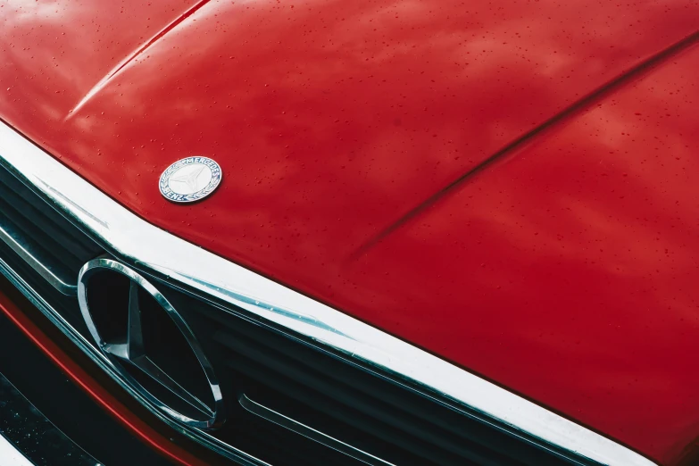 an old car has a shiny chrome emblem