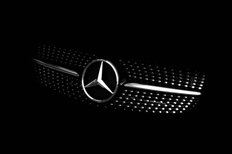 a close - up s of the mercedes logo on the front of a mercedes car