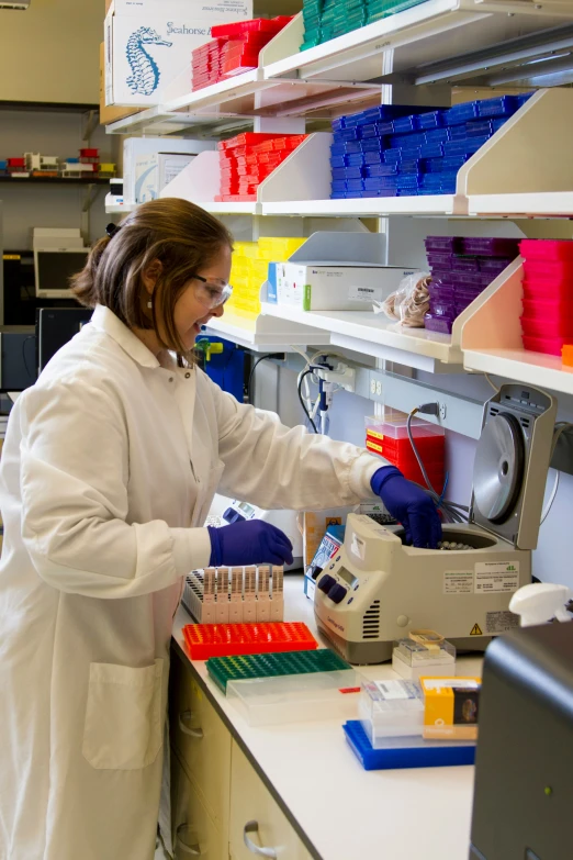 woman at work in lab setting wearing safety equipment