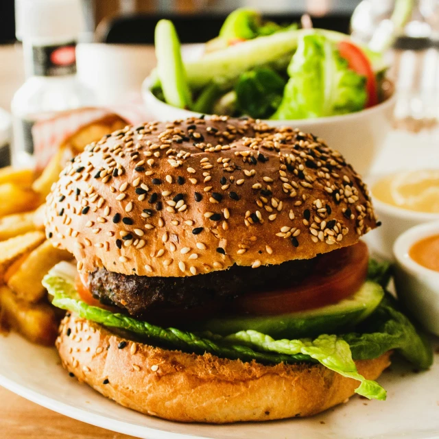 a burger and some french fries are on a white plate