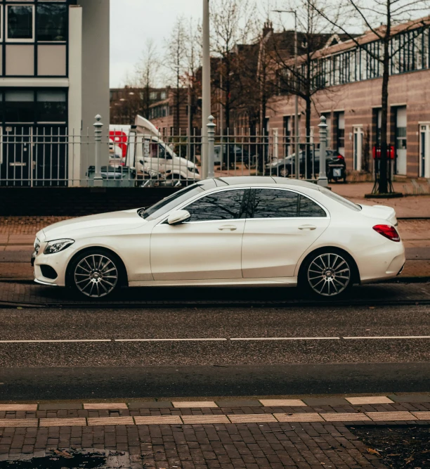 a car is parked at the curb by a street