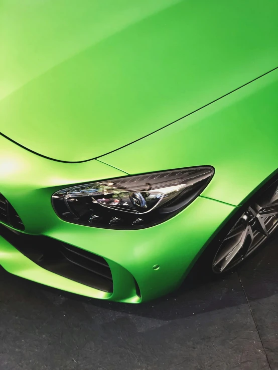 a very green sports car is parked in a parking lot