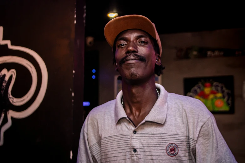 a man wearing a tan hat and white shirt