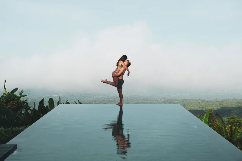 an adult man standing on the edge of a long pool