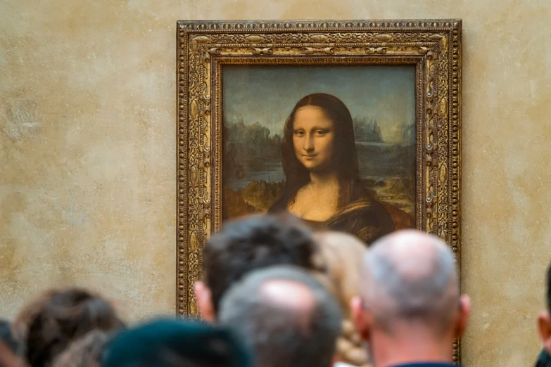 people standing and watching the portrait of jesus in an art gallery