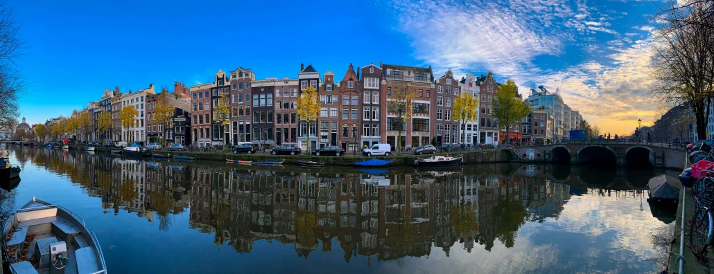 the city is surrounded by a river with boats on it