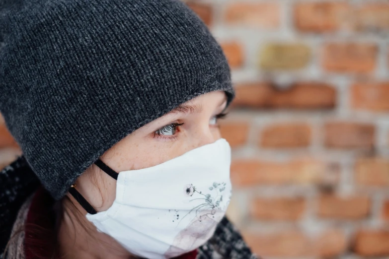 a woman with a protective mask on her face