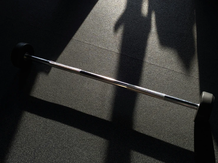a shadow of a person standing by a bar