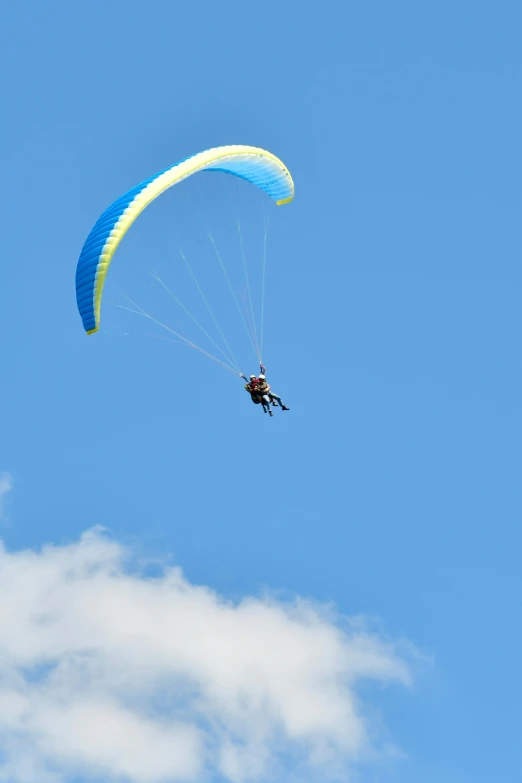 person holding a rope attached to a parachute