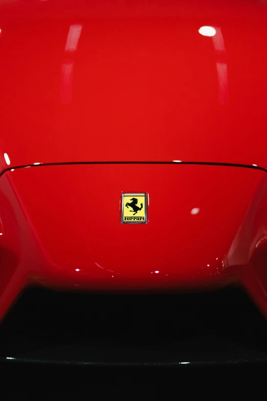 there is a small sticker on a shiny red car