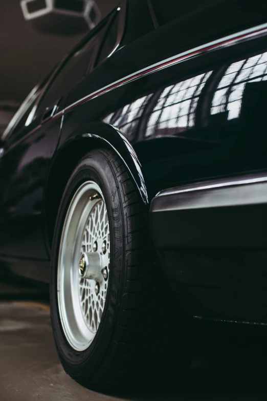 close up of wheels and rims on a black sports car