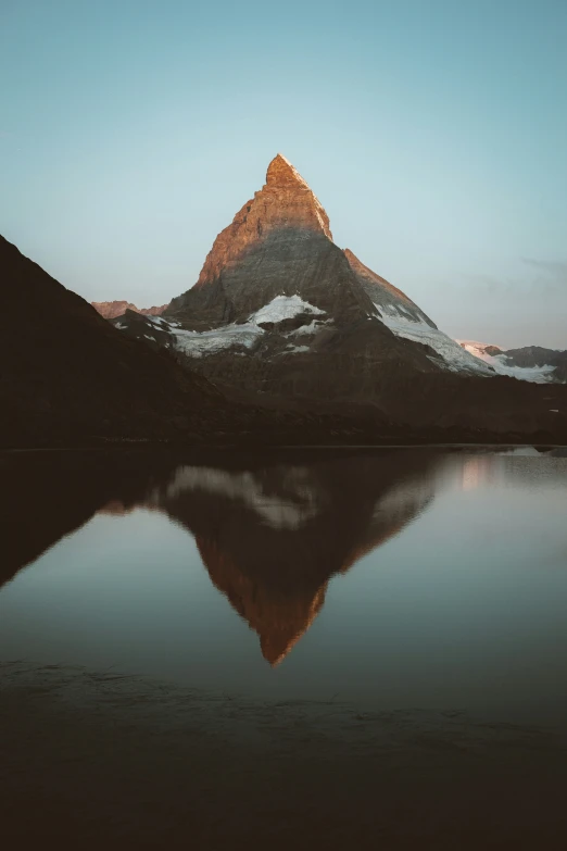 a reflection of a mountain in a lake