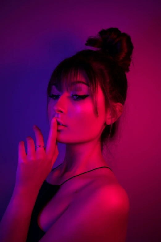 a woman in a black top and pink lights