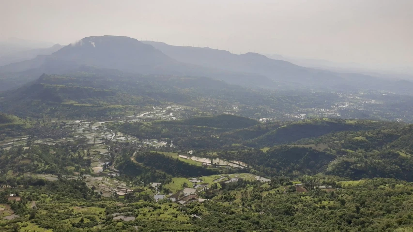 an overexposed mountain range with small town nestled in the foreground