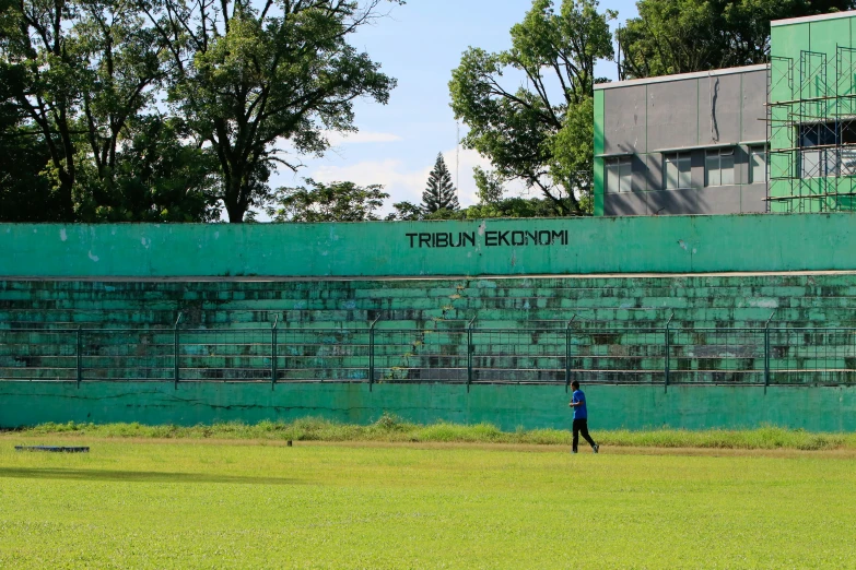 a man in black standing on a baseball field