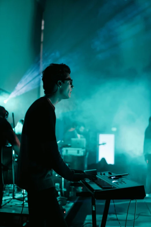 a man plays electronic music on a stage