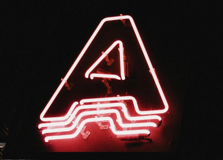 a sign is lit up in the dark